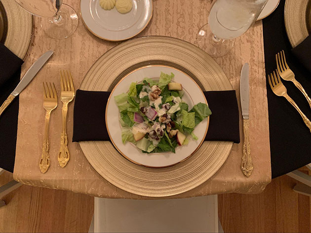 Plated Waldorf salad on a gold plate with gold tableware 