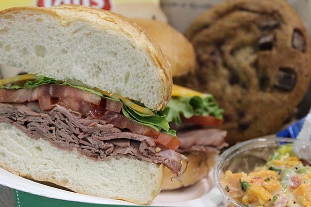 Roast beef sandwich with a cookie and potato salad