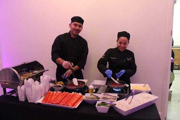 Two happy chefs smiling at an event