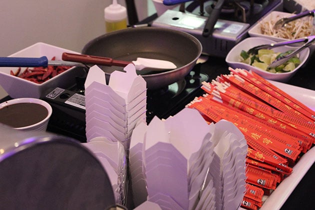 Chinese food Chef Action station including take out boxes and chop sticks