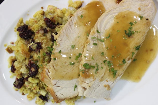 Roasted turkey with gravy and stuffing on a white plate