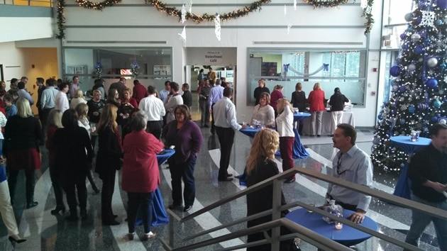Employees mix and mingle at an office holiday party