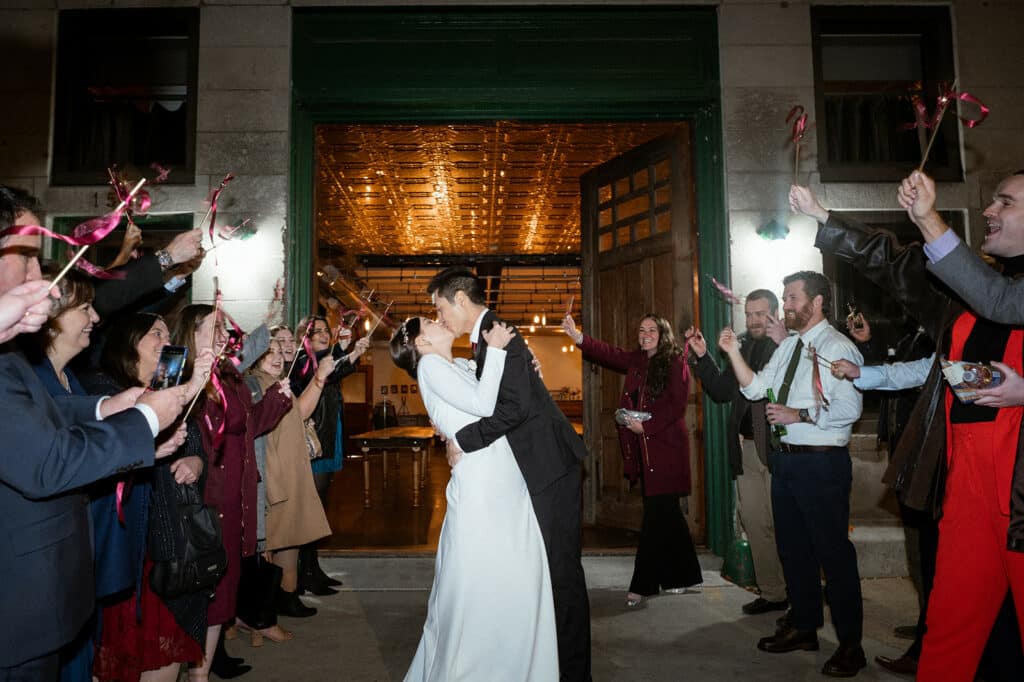 bride groom kiss exiting the wedding