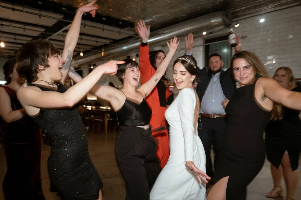 bride dancing with friends