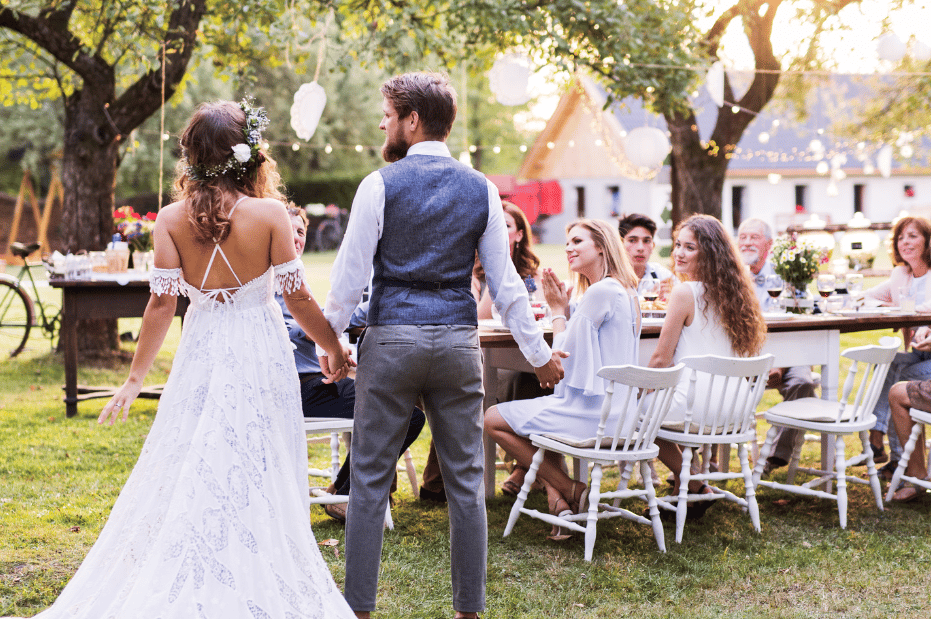 Backyard wedding with bride and groom and guests