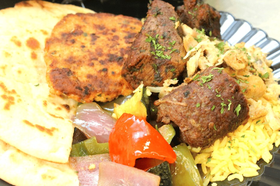 middle eastern food with gyro and rice and vegetables and pita bread (1)