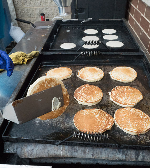 Pancakes being cooked on a flat top grill