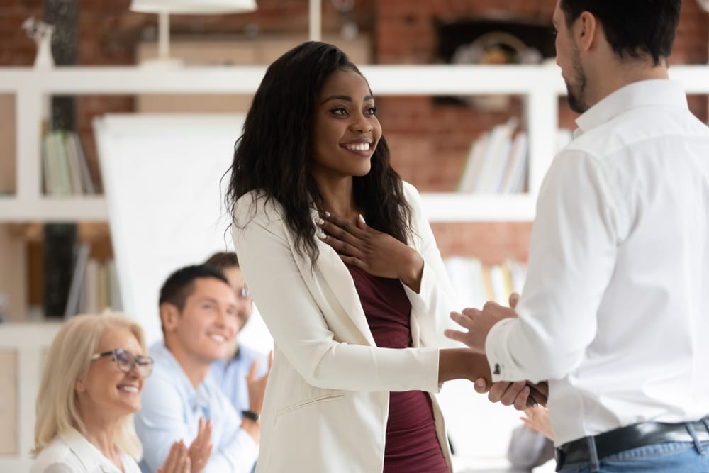 Employee being recognized by her boss at work