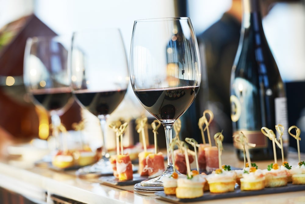 Wine glasses and small appetizers on a counter