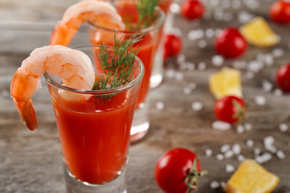 Shrimp cocktail on a shot glass full of cocktail sauce