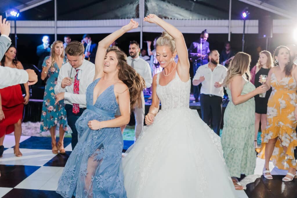 bride dancing with friend on dancefloor